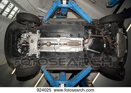 A car on a car lift in a auto repair shop View Large Photo Image Stock Photography - A car on a car lift in a auto repair shop. Fotosearch