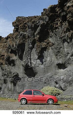 A car parked below rocky cliffs View Large Photo Image Stock Image - A car parked below rocky cliffs. Fotosearch