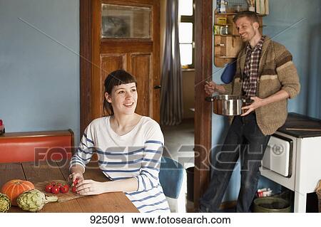 A couple cooking in a domestic kitchen View Large Photo Image Stock Image - A couple cooking in a domestic kitchen. Fotosearch