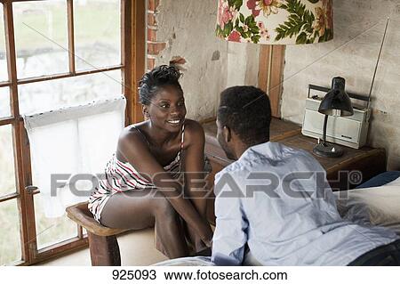 A couple relaxing in their bedroom View Large Photo Image Stock Image - A couple relaxing in their bedroom. Fotosearch