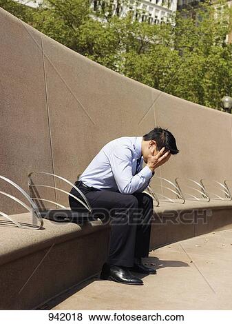 A distraught businessman with his head in hands View Large Photo Image Stock Photo - A distraught businessman with his head in hands. Fotosearch