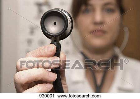 A doctor using a stethoscope View Large Photo Image Stock Image - A doctor using a stethoscope. Fotosearch