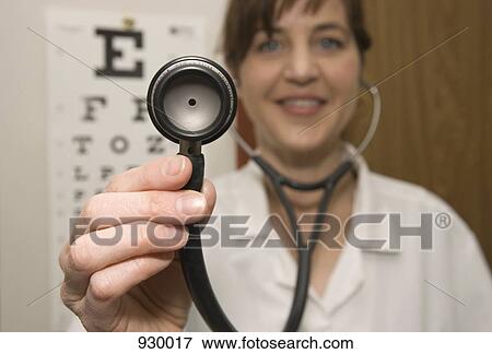 A doctor using a stethoscope View Large Photo Image Stock Photo - A doctor using a stethoscope. Fotosearch