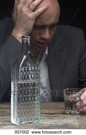 A drunk and depressed businessman holding a glass of vodka View Large Photo Image Stock Image - A drunk and depressed businessman holding a glass of vodka. Fotosearch