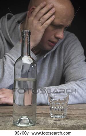 A drunk and depressed man with a bottle of vodka and an empty glass View Large Photo Image Stock Photo - A drunk and depressed man with a bottle of vodka and an empty glass. Fotosearch