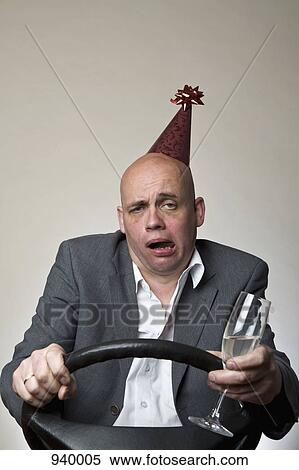 A drunk man behind a car steering wheel View Large Photo Image Stock Photography - A drunk man behind a car steering wheel. Fotosearch