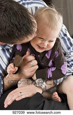 A father hugging and kissing his daughter View Large Photo Image Stock Photo - A father hugging and kissing his daughter. Fotosearch