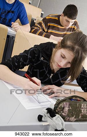 A female high school student doing school work in a classroom View Large Photo Image Stock Image - A female high school student doing school work in a classroom. Fotosearch