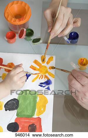 Picture - A girl and two women painting, close-up, directly above. Fotosearch