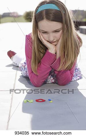 A girl looking at NO spelt in felt letters View Large Photo Image Stock Photography - A girl looking at NO spelt in felt letters. Fotosearch