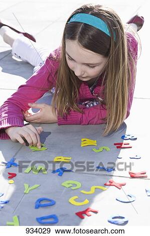 A girl playing with felt alphabet letters View Large Photo Image Stock Photo - A girl playing with felt alphabet letters. Fotosearch