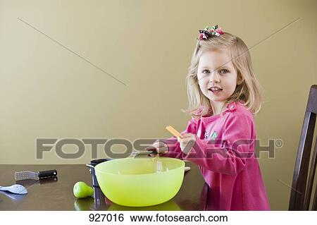 A girl playing with toy food and cooking utensils View Large Photo Image Stock Photograph - A girl playing with toy food and cooking utensils. Fotosearch
