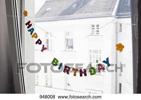 A HAPPY BIRTHDAY sign hanging in front of a window View Large Photo Image Stock Photo - A HAPPY BIRTHDAY sign hanging in front of a window. Fotosearch