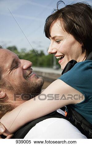 A happy couple hugging View Large Photo Image Stock Photography - A happy couple hugging. Fotosearch