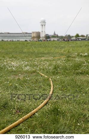 A hose running through a field View Large Photo Image Stock Image - A hose running through a field. Fotosearch