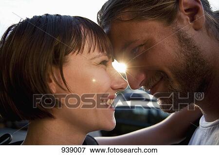Stock Photo - A loving young couple, face to face, close-up. Fotosearch