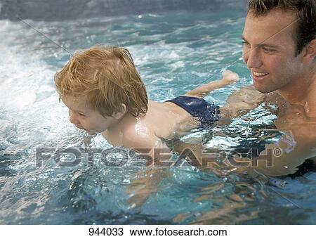 A man and a baby boy in a swimming pool View Large Photo Image Stock Image - A man and a baby boy in a swimming pool. Fotosearch