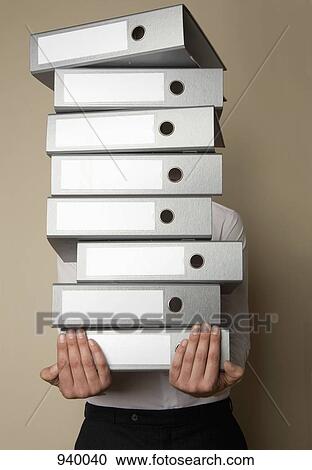 A man carrying a stack of folders View Large Photo Image Stock Image - A man carrying a stack of folders. Fotosearch