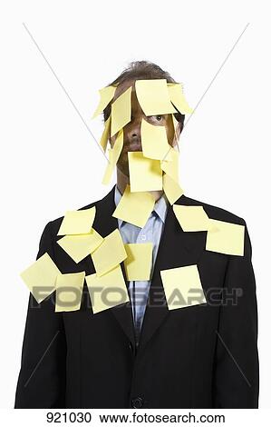 Stock Image - A man covered in blank adhesive notes and looking away. Fotosearch
