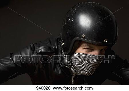 A man wearing a helmet, bandana mask and leather jacket View Large Photo Image Stock Image - A man wearing a helmet, bandana mask and leather jacket. Fotosearch