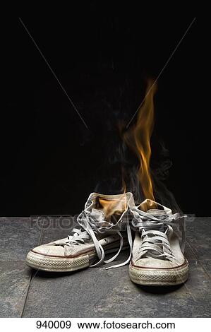 A pair of canvas shoes on fire View Large Photo Image Stock Photo - A pair of canvas shoes on fire. Fotosearch