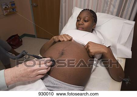 A pregnant woman receiving an ultrasound View Large Photo Image Stock Image - A pregnant woman receiving an ultrasound. Fotosearch