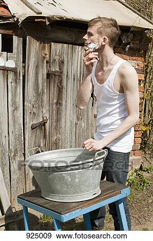 A rustic man shaving outdoors View Large Photo Image Stock Photo - A rustic man shaving outdoors . Fotosearch