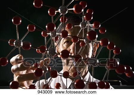 A scientist holding a molecular structure model View Large Photo Image Stock Photo - A scientist holding a molecular structure model. Fotosearch