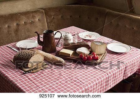 Stock Photo - A simple rustic meal laid out on a set table. Fotosearch