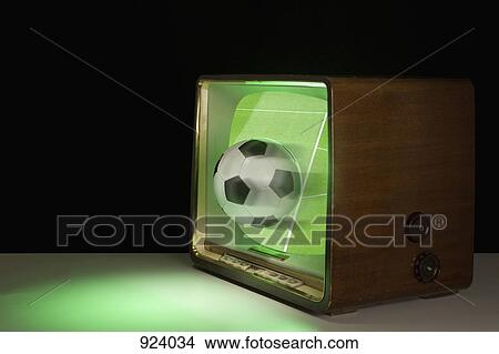 A soccer ball coming out of a television View Large Photo Image Picture - A soccer ball coming out of a television. Fotosearch