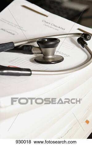 A stethoscope on top of a stack of medical charts View Large Photo Image Stock Photo - A stethoscope on top of a stack of medical charts. Fotosearch