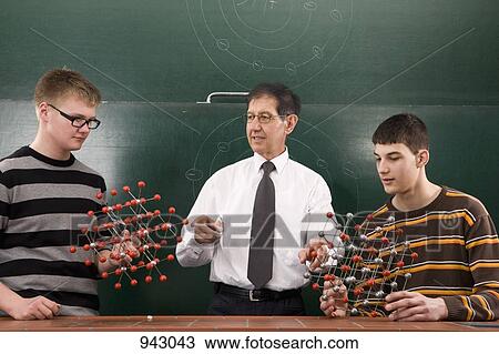 A teacher showing students molecular structure models View Large Photo Image Stock Image - A teacher showing students molecular structure models. Fotosearch