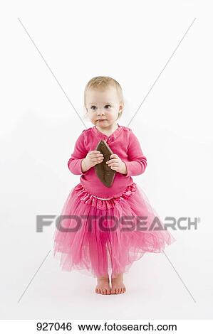 A toddler clutching chocolate and looking away View Large Photo Image Stock Photograph - A toddler clutching chocolate and looking away . Fotosearch