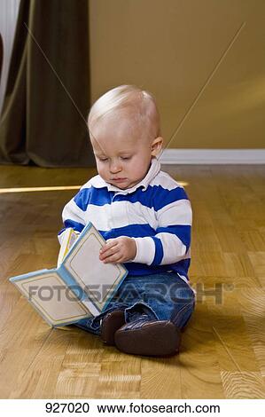 A toddler looking at a book View Large Photo Image Stock Image - A toddler looking at a book. Fotosearch