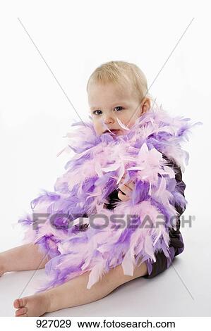 A toddler wearing a feather boa View Large Photo Image Stock Photo - A toddler wearing a feather boa. Fotosearch