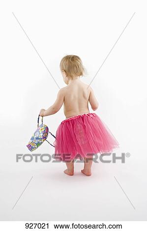 A toddler wearing a tutu and holding a purse, studio shot View Large Photo Image Stock Image - A toddler wearing a tutu and holding a purse, studio shot. Fotosearch