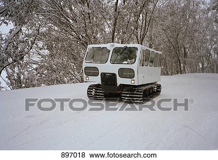 Stock Photo - A tracked vehicle on a snowy road. Fotosearch