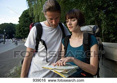 A young backpacker couple looking at a city map View Large Photo Image Stock Photograph - A young backpacker couple looking at a city map. Fotosearch