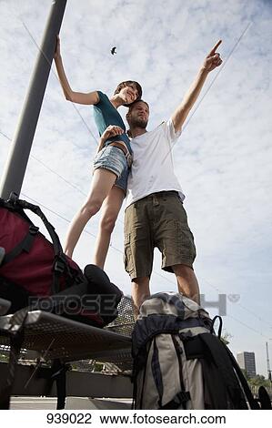 A young couple having fun while waiting on a train platform View Large Photo Image Stock Image - A young couple having fun while waiting on a train platform. Fotosearch