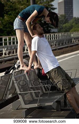 A young couple having fun while waiting on a train platform View Large Photo Image Stock Photo - A young couple having fun while waiting on a train platform. Fotosearch