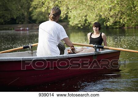 Picture - A young couple in a rowboat. Fotosearch