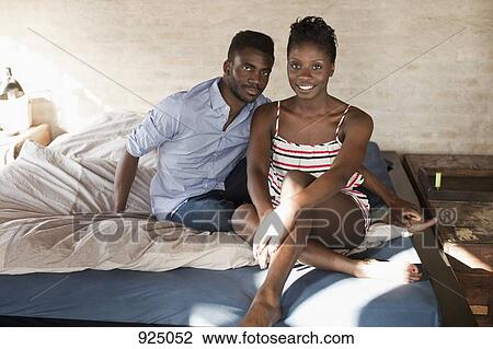 A young couple relaxing in bed View Large Photo Image Stock Image - A young couple relaxing in bed. Fotosearch