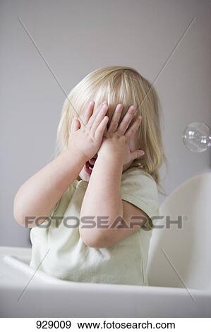 A young girl covering her face with her hands View Large Photo Image Stock Photo - A young girl covering her face with her hands. Fotosearch