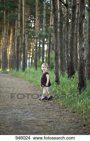 Picture - A young girl wearing a woman's high heels. Fotosearch