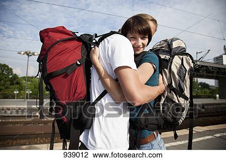A young woman hugging her boyfriend on a train platform View Large Photo Image Stock Image - A young woman hugging her boyfriend on a train platform. Fotosearch
