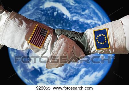 An American astronaut shaking hands with an astronaut from the European Union View Large Photo Image Stock Photography - An American astronaut shaking hands with an astronaut from the European Union. Fotosearch