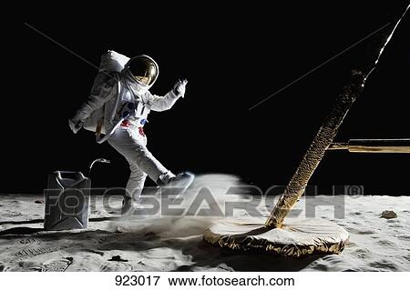 Stock Photo - An angry astronaut out of gas on the moon. Fotosearch