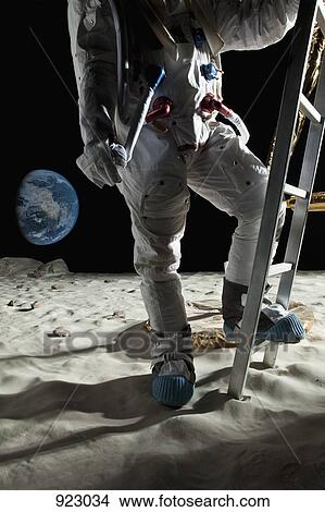 An astronaut climbing the ladder of a lunar lander on the moon View Large Photo Image Picture - An astronaut climbing the ladder of a lunar lander on the moon. Fotosearch