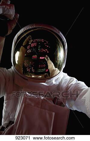 An astronaut in space making adjustments to a control panel View Large Photo Image Stock Image - An astronaut in space making adjustments to a control panel. Fotosearch