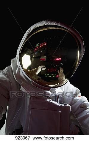 Stock Photo - An astronaut in space making adjustments to a control panel. Fotosearch